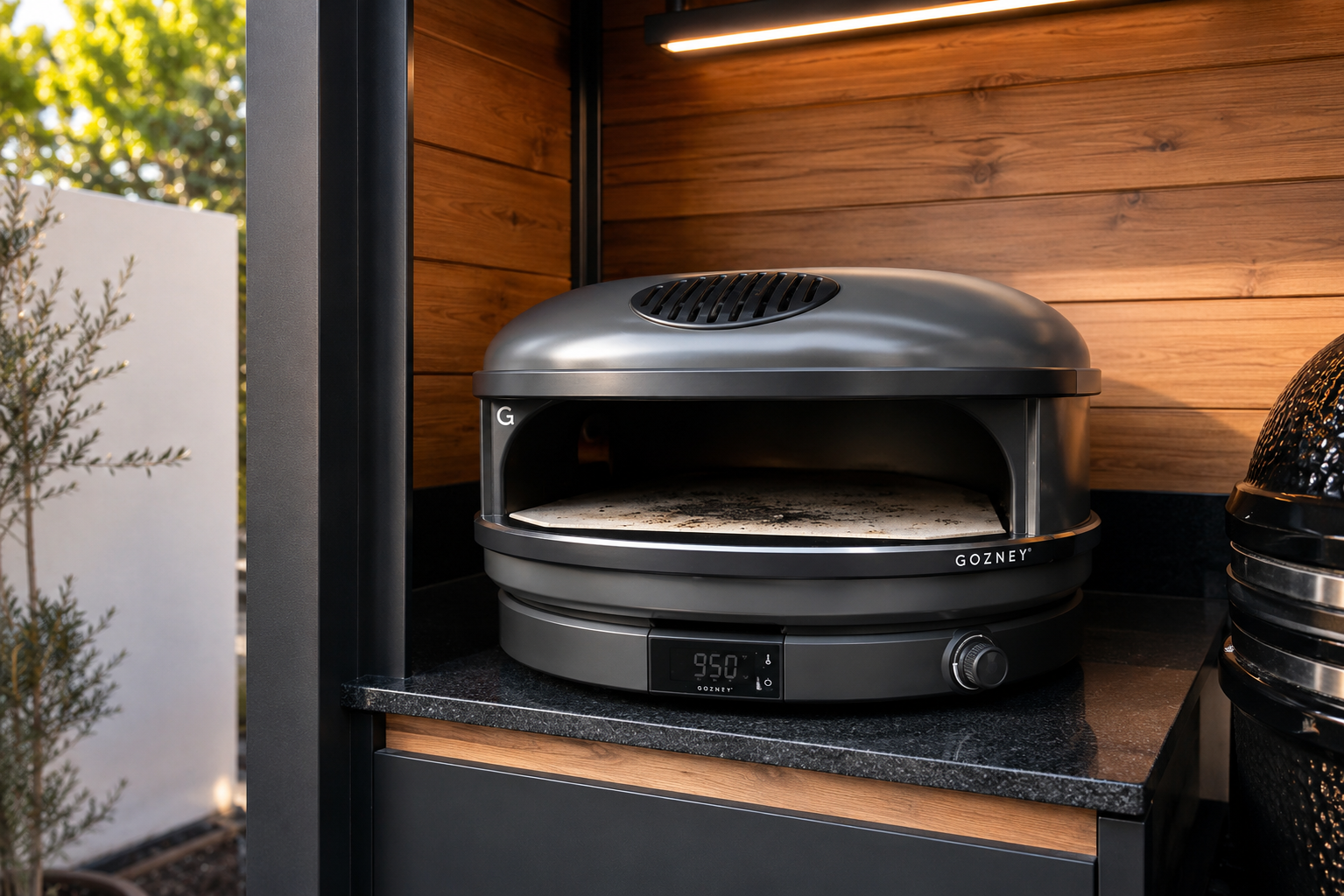 Close-up of the integrated pizza oven on the stone countertop in Pod 03